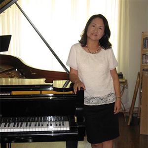 Woman standing next to a piano